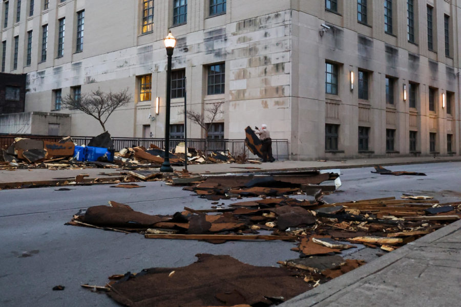 After high winds blew through the city, an officer throws debris from the roof of Robert F. Stephens Circuit Courthouse on Friday, March 3, 2023, in Lexington, Kentucky. Photo by Abbey Cutrer | Staff