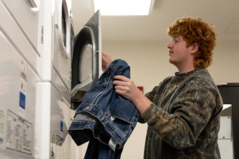 Freshman Jack Brooks unloads laundry in Holmes Hall on Tuesday, March 28, 2023, at the University of Kentucky in Lexington, Kentucky. Photo by Brady Saylor | Staff