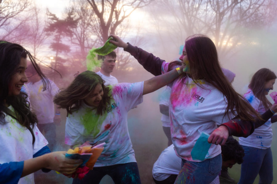 Students participate in the color throwing and pour color on each other during the Holi celebration put on by the Student Activities Board and Indian Student Association on Wednesday, March 8, 2023, at the Main Lawn in Lexington, Kentucky. Photo by Carter Skaggs | Staff