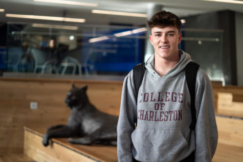 Freshman Garrett Nealen poses for a portrait on Monday, Feb. 27, 2023, at the Gatton Student Center in Lexington, Kentucky. Nealen said he chose the sweatshirt because he found it buried in his closet. Photo by Carter Skaggs | Staff