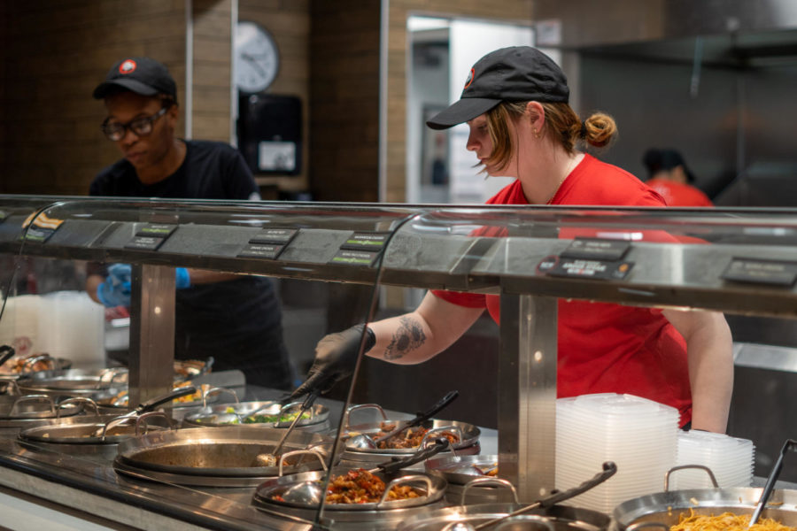 Freshman nursing major Katie Ray stirs a bowl of orange chicken while working at Panda Express in the Gatton Student Center on Monday, Feb. 20, 2023, in Lexington, Kentucky. Photo by Carter Skaggs | Staff