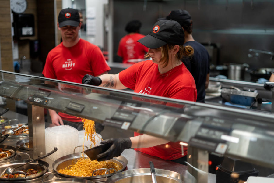 Freshman nursing major Katie Ray fills a customer’s bowl while working at Panda Express in the Gatton Student Center on Monday, Feb. 20, 2023, in Lexington, Kentucky. Photo by Carter Skaggs | Staff