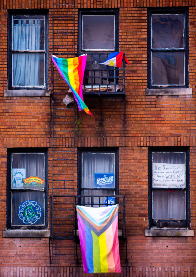 Pride flags are hung on a buildings balconies near the Queer Youth Visibility March on Friday, March 31, 2023, in downtown Lexington in Lexington, Kentucky. Photo by Samuel Colmar | Staff