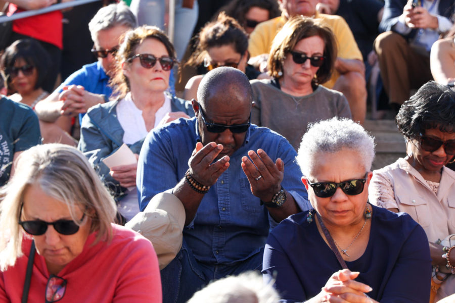 People bow their heads in prayer during the community vigil honoring the victims of the Louisville mass shooting on Wednesday, April 12, 2023, at the Muhammad Ali Center plaza in Louisville, Kentucky. Kentucky Lantern photo by Abbey Cutrer