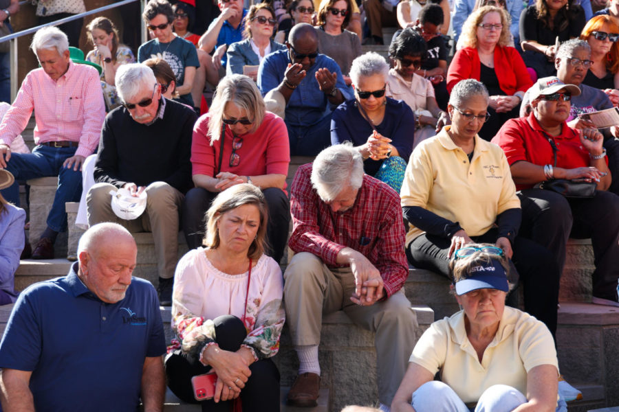 People bow their heads in prayer during the community vigil honoring the victims of the Louisville mass shooting on Wednesday, April 12, 2023, at the Muhammad Ali Center plaza in Louisville, Kentucky. Kentucky Lantern photo by Abbey Cutrer