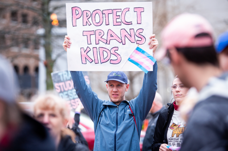 A demonstrator holds a sign during the Queer Youth Visibility March on Friday, March 31, 2023, in downtown Lexington in Lexington, Kentucky. Photo by Samuel Colmar | Staff