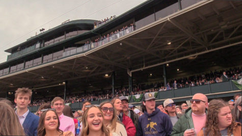 Attendees watch as Horses cross the finish line on Friday, April. 7, 2023, at Keeneland in Lexington, Kentucky. Photo by Bryce Towle | Staff