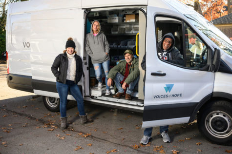 Voices of Hope team members stand in their mobile engagement unit. Photo provided by cofounder Alexander Elswick.
