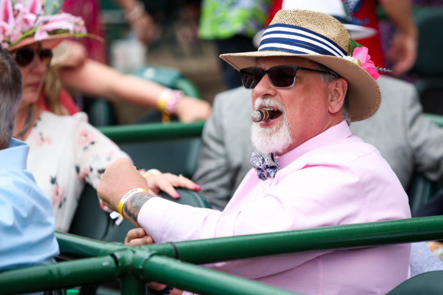 A Derby goer bites his cigar during the 149th Kentucky Derby on Saturday, May 6, 2023, in Churchill Downs in Louisville, Kentucky. Photo by Samuel Colmar | Staff