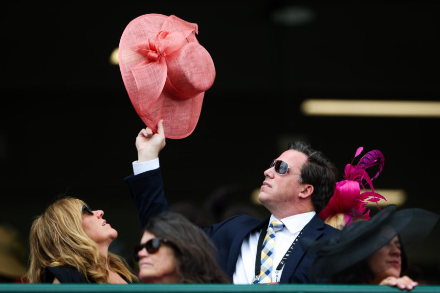 A Derby goer holds a hat during the 149th Kentucky Derby on Saturday, May 6, 2023, in Churchill Downs in Louisville, Kentucky. Photo by Samuel Colmar | Staff