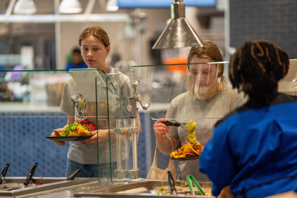 Students fill their plates in Champions Kitchen on Friday, Aug. 19, 2023, in Lexington, Kentucky. Photo by Travis Fannon | Staff