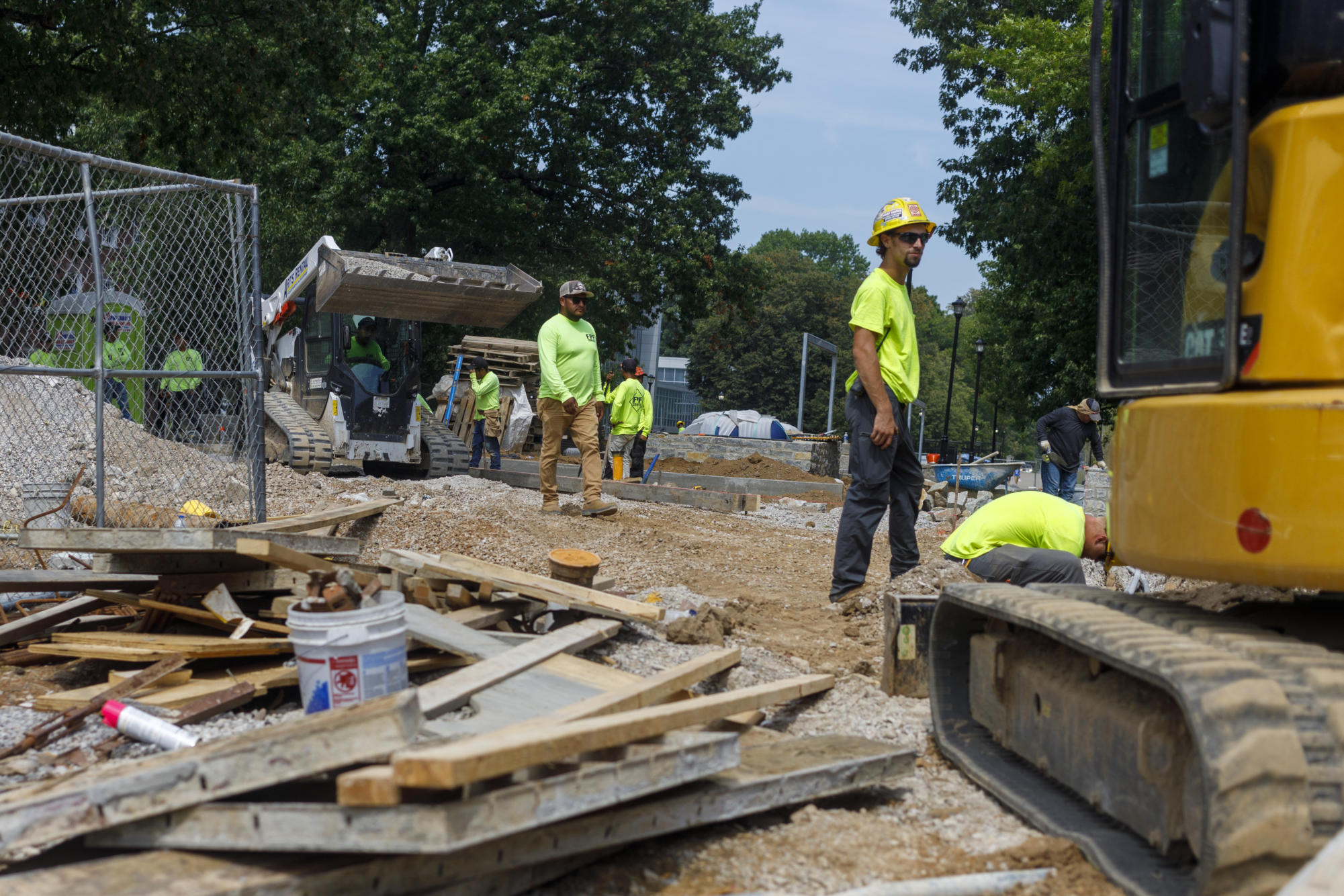 Construction workers walk through the site on Thursday, Aug. 24, 2023, at Alumni Commons in Lexington, KY. Photo by Matthew Mueller | Staff