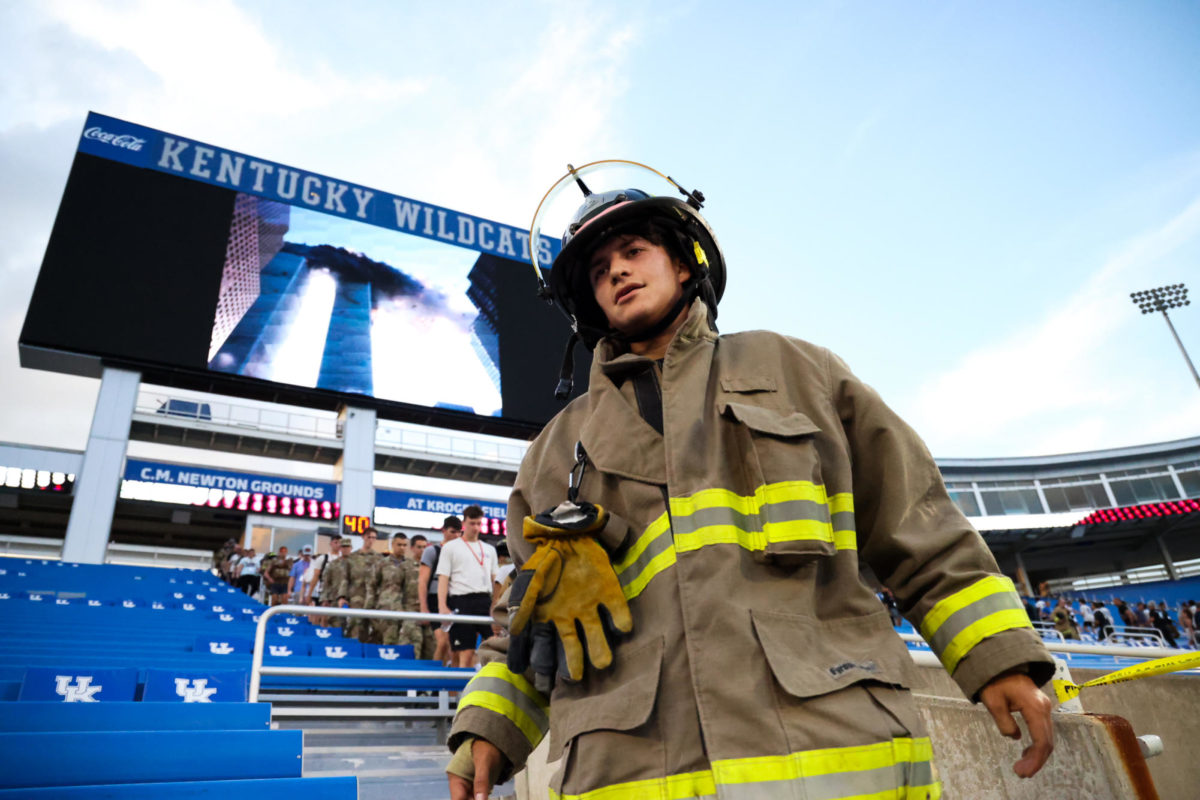 An image of the the twin towers burning is displayed on the scoreboard while members of the fire department participate in the 9/11 Memorial Stair Climb on Monday, Sept. 11, 2023, at Kroger Field in Lexington, Kentucky. Over 500 people gathered to honor the first responders who gave their lives rushing into the World Trade Center on 9/11. Photo by Abbey Cutrer | Staff