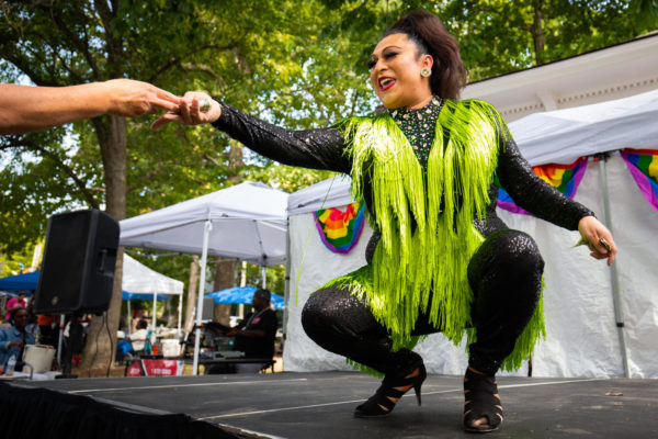 Mia Milan accepts a tip during her performance at the drag show during the annual Kentucky Black Pride Festival on Saturday, Sept. 16, 2023, at Woodland Park in Lexington, Kentucky. Photo by Samuel Colmar | Staff