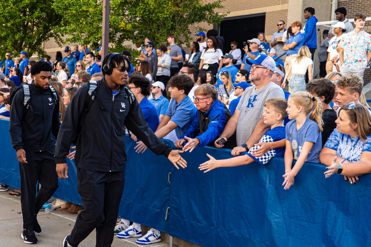 Kentucky football players high-fives fans during the Cat Walk prior to the Kentucky vs Florida football game on Saturday, Sept. 30, 2023, at Kroger Field in Lexington, Kentucky. Photo by Isaiah Pinto Staff