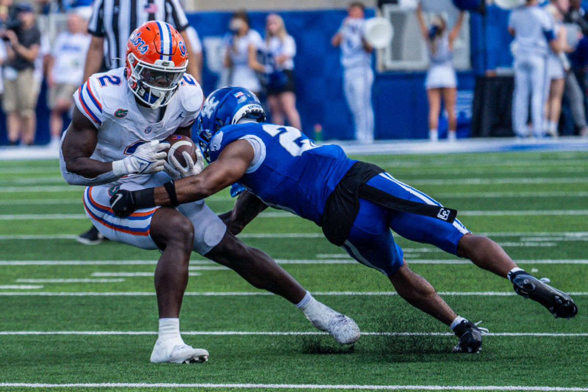 Kentucky Wildcats defensive back Andre Phillips (23) wraps up Florida Gators Montrell Johnson Jr. (2) during the Kentucky vs. Florida football game on Saturday, Sept. 30, 2023, at Kroger Field in Lexington, Kentucky. UK won 33-14. Photo by Isaiah Pinto | Staff
