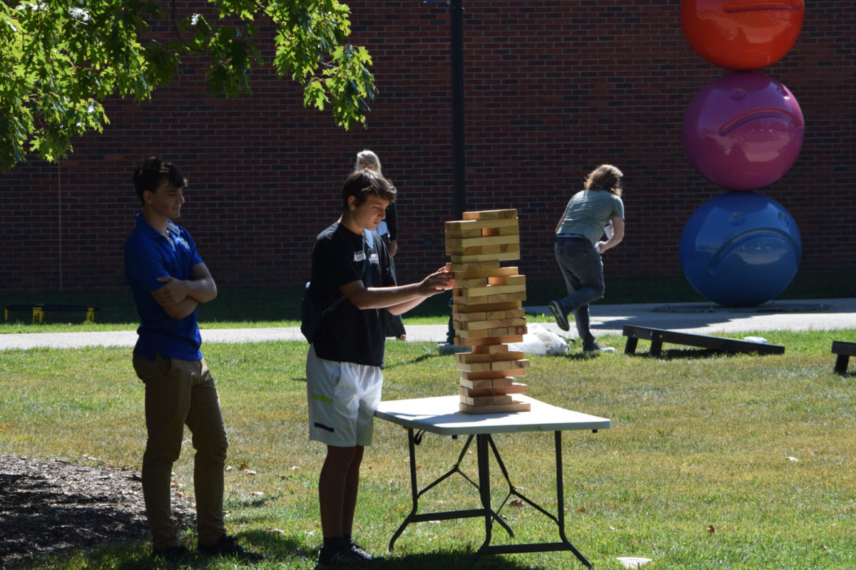 Students play Jenga at the University of Kentucky Family Weekend Tent Party on Saturday, Sep. 23, 2023 at Stoll Field in Lexington, Kentucky. Photo by Gracie Moore | Staff