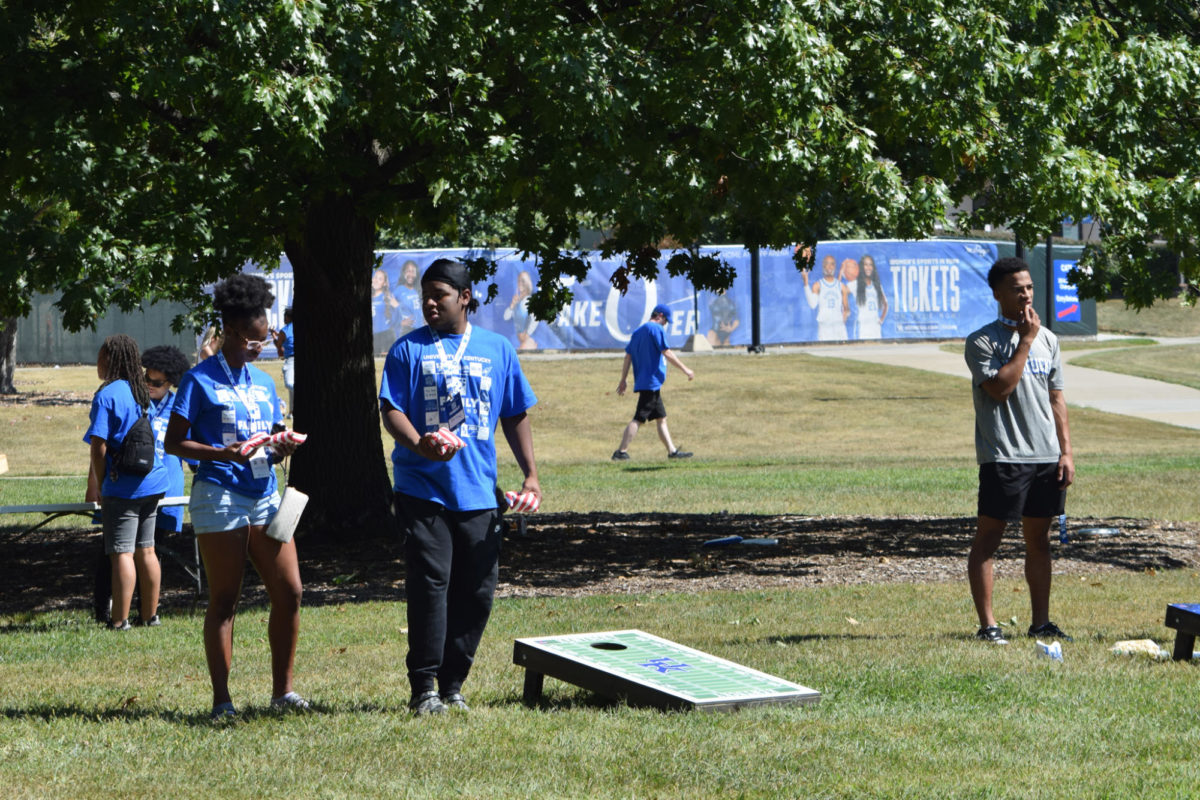 Students and families play cornhole at the University of Kentucky Family Weekend Tent Party on Saturday, Sep. 23, 2023 at Stoll Field in Lexington, Kentucky. Photo by Gracie Moore | Staff