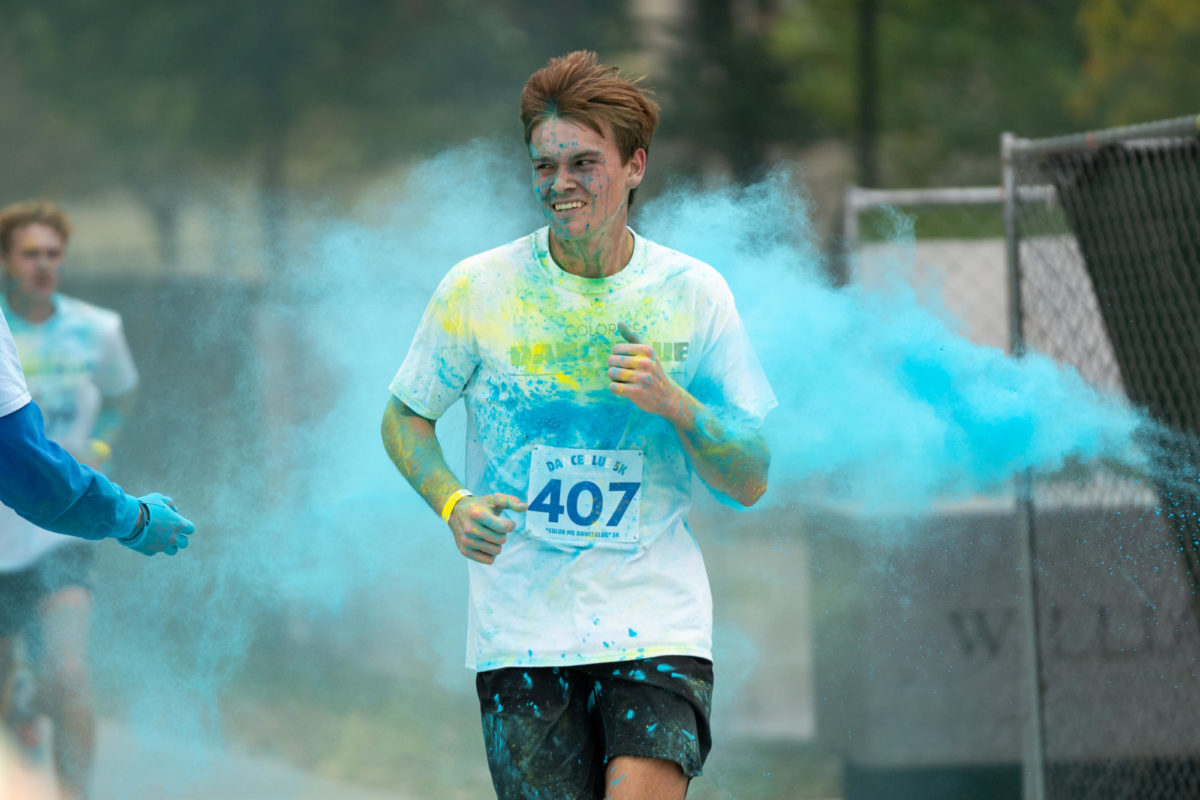 Runners are pelted with color during the Dance Blue 5K Color Run on Sunday, Oct. 8, 2023, at the University of Kentucky in Lexington, Kentucky. Photo by Travis Fannon | Staff