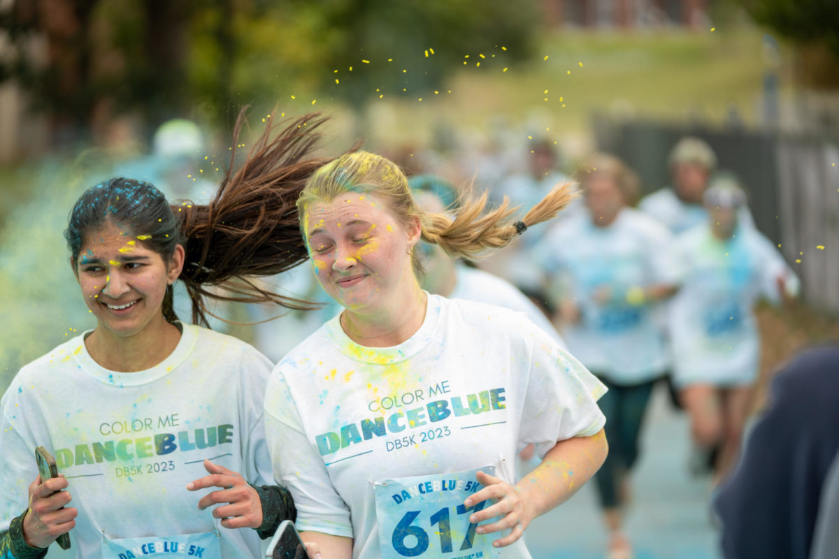 Runners are splashed with paint during the Dance Blue 5K Color Run on Sunday, Oct. 8, 2023, at the University of Kentucky in Lexington, Kentucky. Photo by Travis Fannon | Staff