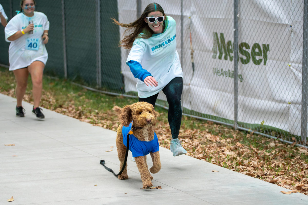 A puppy gets away from its owner during the Dance Blue 5K Color Run on Sunday, Oct. 8, 2023, at the University of Kentucky in Lexington, Kentucky. Photo by Travis Fannon | Staff