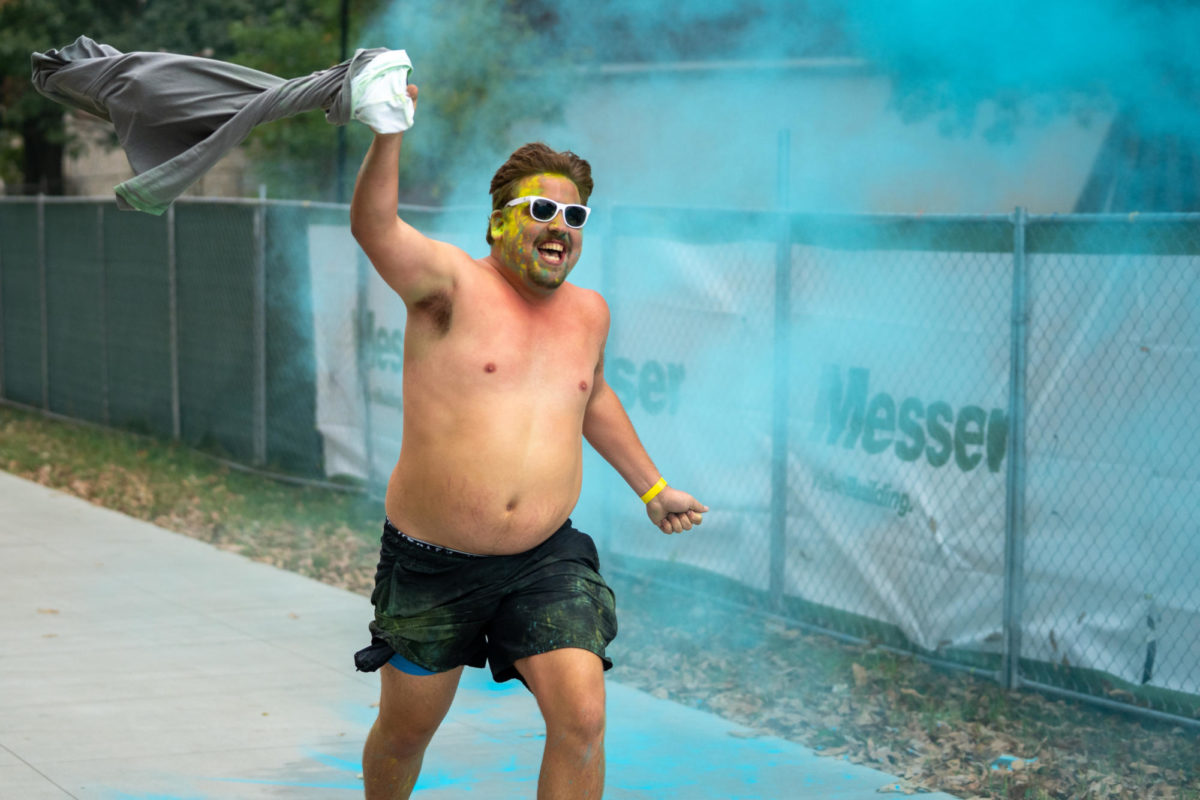 A man runs shirtless during the Dance Blue 5K Color Run on Sunday, Oct. 8, 2023, at the University of Kentucky in Lexington, Kentucky. Photo by Travis Fannon | Staff