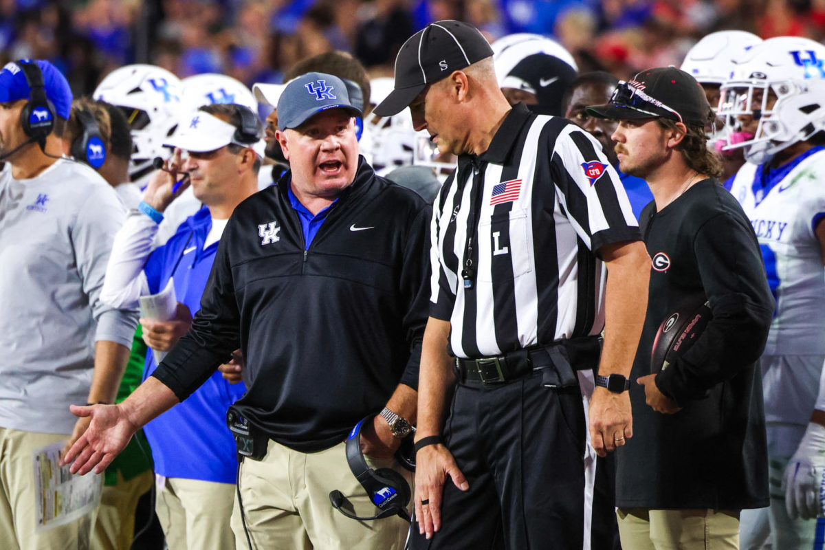 Kentucky head coach Mark Stoops speaks with a referee during the Kentucky vs. Georgia football game on Saturday, Oct. 7, 2023, at Sanford Stadium in Athens, Georgia. Kentucky lost 51-13. Photo by Samuel Colmar | Staff