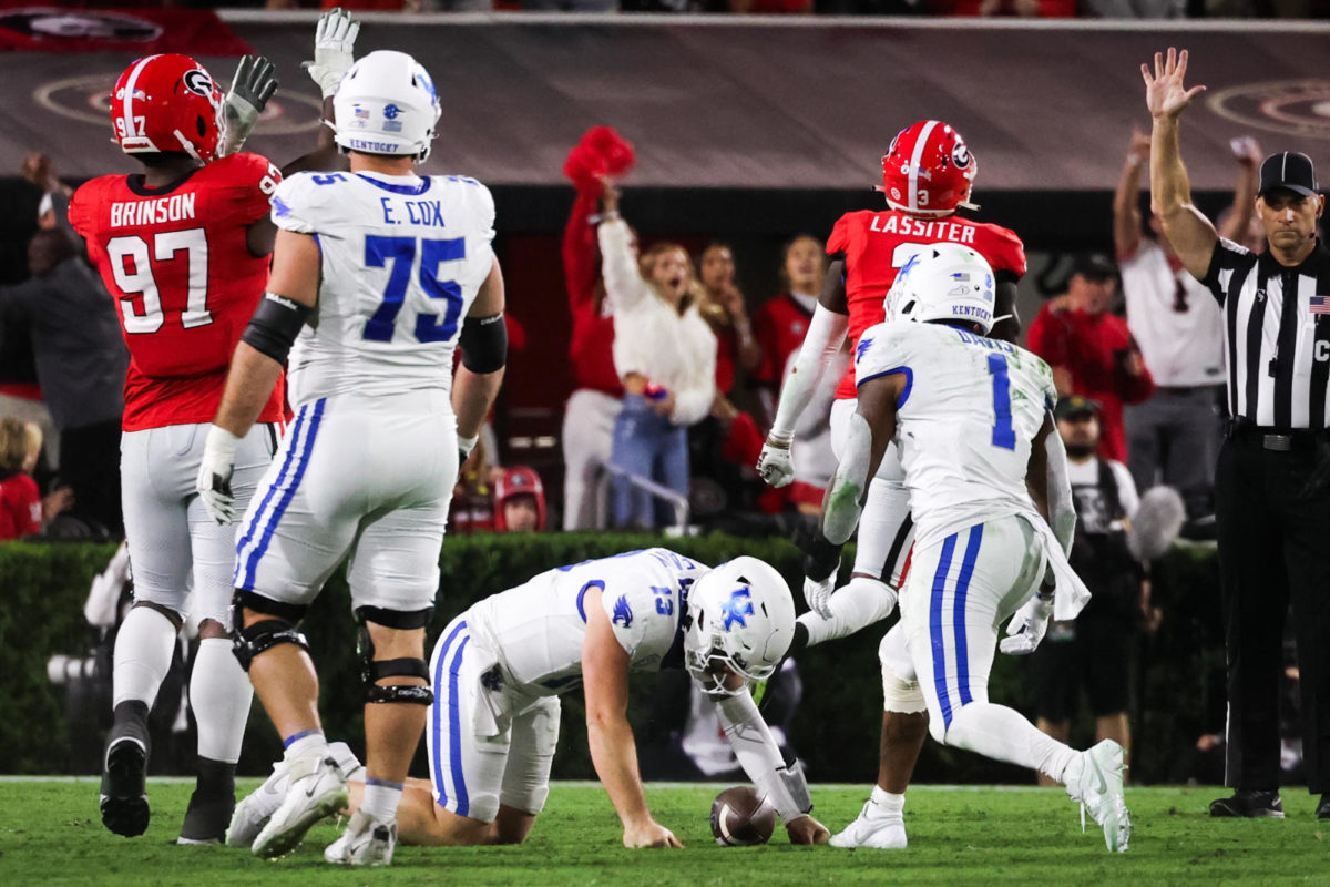 Kentucky quarterback Devin Leary (13) is sacked during the Kentucky vs. Georgia football game on Saturday, Oct. 7, 2023, at Sanford Stadium in Athens, Georgia. Kentucky lost 13-51. Photo by Samuel Colmar | Staff