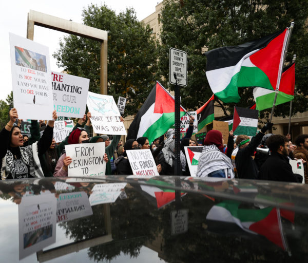 People hold signs and flags during the “All out for Palestine” rally on Tuesday, Oct. 17, 2023, outside of the Robert F. Stephens Circuit Courthouse in downtown Lexington, Kentucky. Photo by Abbey Cutrer | Staff