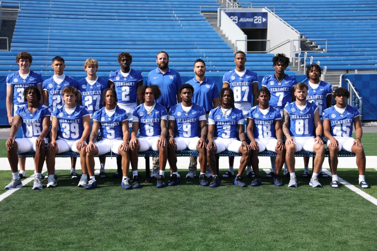 The Kentucky Wildcats wide receivers pose for a photo with coach Scott Woodward during Media Day on Friday, Aug. 4, 2023, at Kroger Field in Lexington, Kentucky. Photo by Abbey Cutrer | Staff