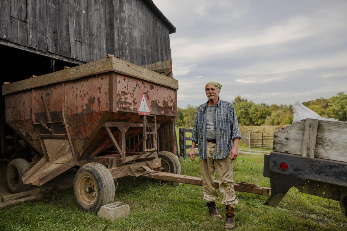 Keenan Bishop stands next to a gravity feeder on his father’s farm on Wednesday, Oct. 11, 2023, in Frankfort, Ky. Bishop has taken responsibility for taking care of his 83-year-old father’s farm, where he tries to visit every night if possible. Photo by Rana Alsoufi