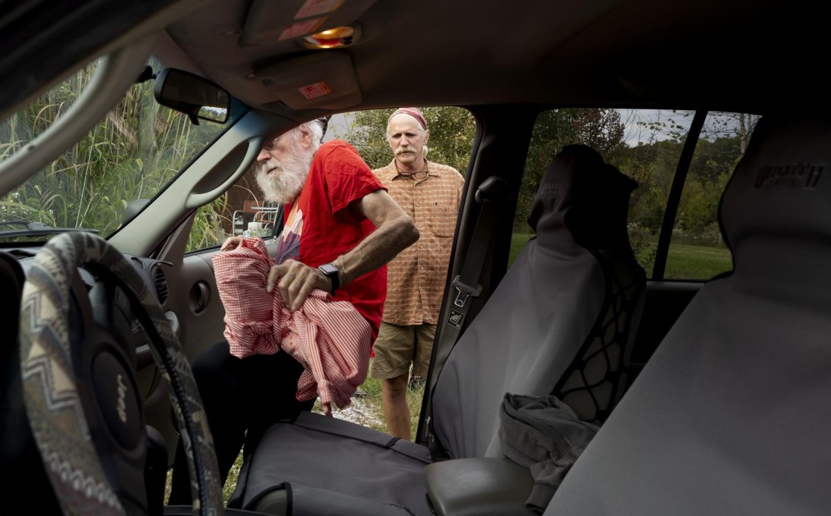 Keenan Bishop, right, watches his father Reid enter the passenger seat of his car on Friday, Oct. 13, 2023, in Frankfort, Ky. The two were on their way to Lexington to celebrate Keenan’s daughter Carley’s 22nd birthday. Photo by Rana Alsoufi