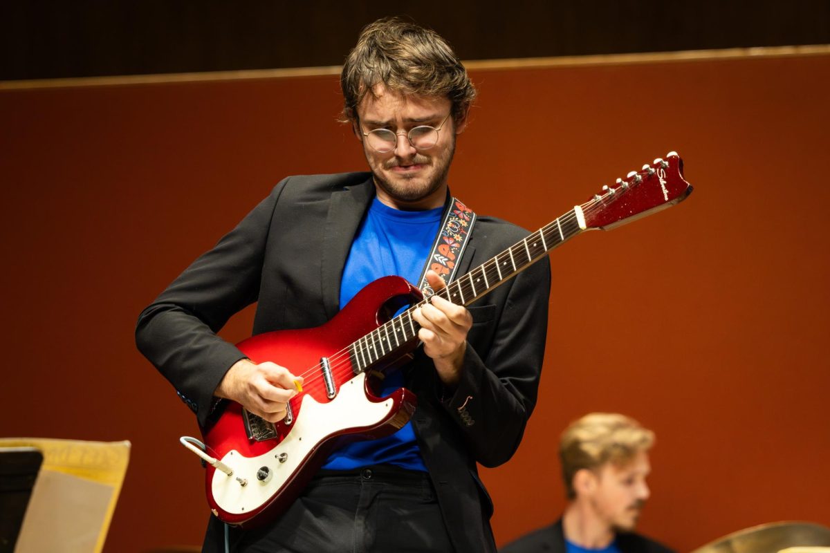 A guitarist performs a solo during the UK Jazz Ensemble concert on Thursday, Nov. 2, 2023, at the Singletary Center for the Arts in Lexington, Kentucky. Photo by Samuel Colmar | Staff