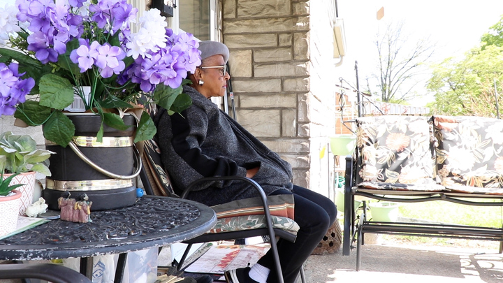 Melody Clark sits on the porch of her renovated home in Lexington, Ky., Monday, April 24, 2023. Photo by Jackson Huston | Staff