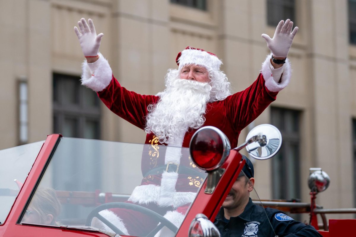 Santa Claus waves to the crowd during the 2023 Lexington Christmas Parade on Saturday, Dec. 2, 2023, in Lexington, Kentucky. Photo by Travis Fannon | Staff
