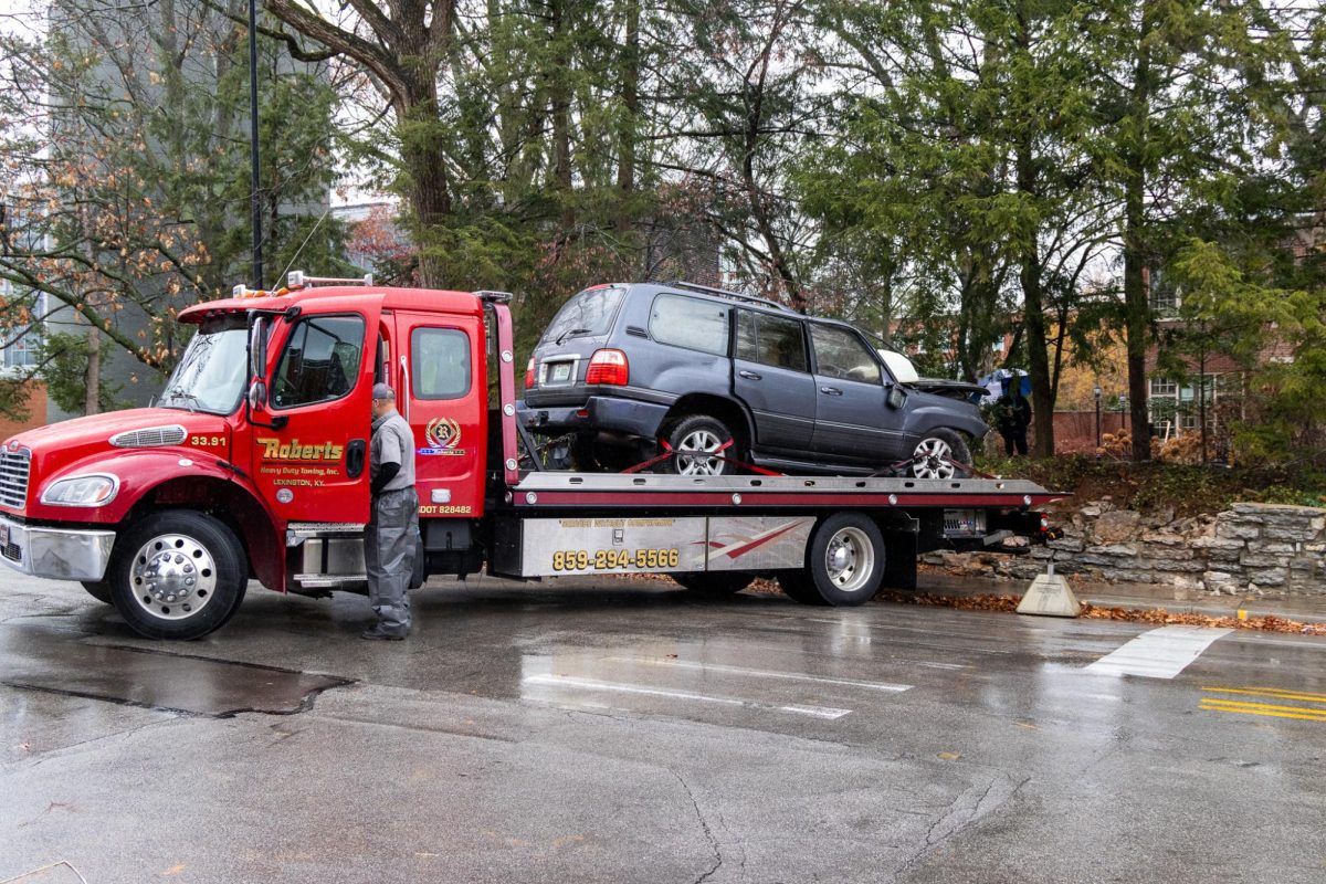A tow truck pulls out a car that crashed into the front lawn of Maxwell Place, where President Eli Capilouto lives, on Monday, Dec. 4, 2023, at the University of Kentucky in Lexington, Kentucky. Photo by Travis Fannon | Staff