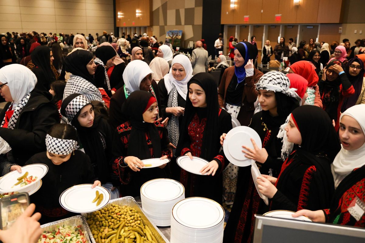 Attendees get in line for food during an event celebrating a living Palestine on Friday, Dec. 15, 2023, in the Gatton Student Center, at the University of Kentucky in Lexington, Kentucky. Photo by Abbey Cutrer | Staff