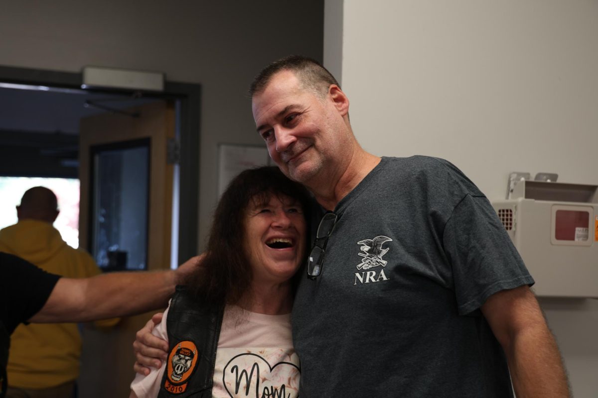 Brian Pedigo, left, hugs Marcia Mullins, during the ACCESS Soup Kitchen and Men’s Shelter daily lunch, on Friday, Oct. 13, 2023 in Frankfort, KY. Photo by Hannah Stanley