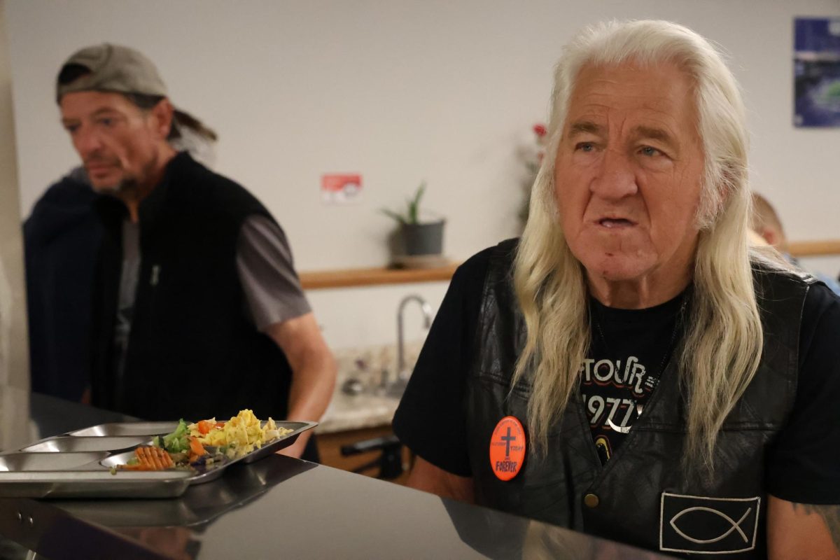 Donald Mullins, right, waits at the counter while volunteers and men staying in the ACCESS Soup Kitchen and Men’s Shelter serve lunch on Thursday, Oct. 12, 2023 in Frankfort, KY. Photo by Hannah Stanley