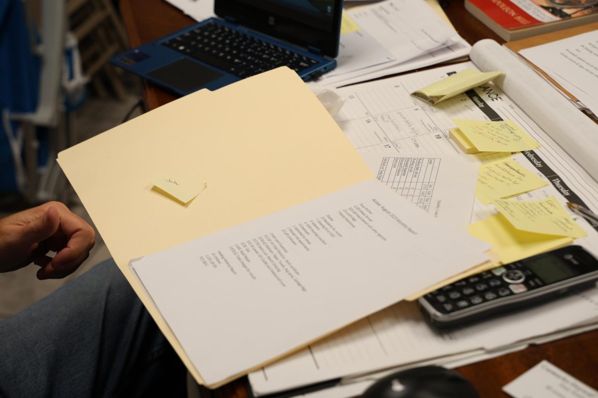 The August report for the ACCESS Soup Kitchen and Men’s Shelter lies on Brian Pedigo’s desk on Thursday, Oct. 12, 2023, in Frankfort, Ky. Photo by Hannah Stanley