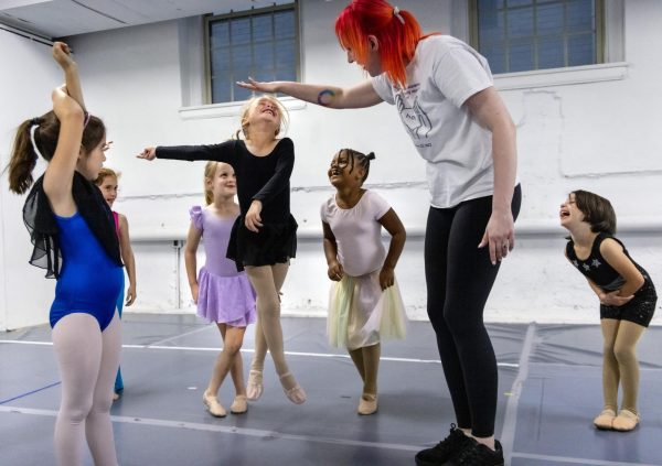 Students laugh and smile as Kares Waterfield jumps to reach dance instructor Amanda Whites’ hand in their ballet class on Thursday, Oct. 12, 2023 at Kentucky Dance Academy in Frankfort, Kentucky.
