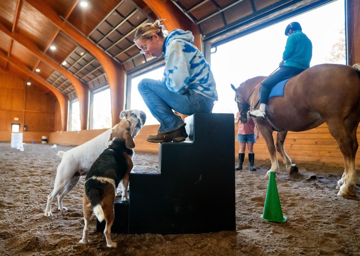 Betsy Grewe, Equestrian Program Director, talking to her dogs during a training session on Friday, Oct 13, 2023, in the training arena on Stewart Home School’s campus. Photo by Carlee Hogsten.