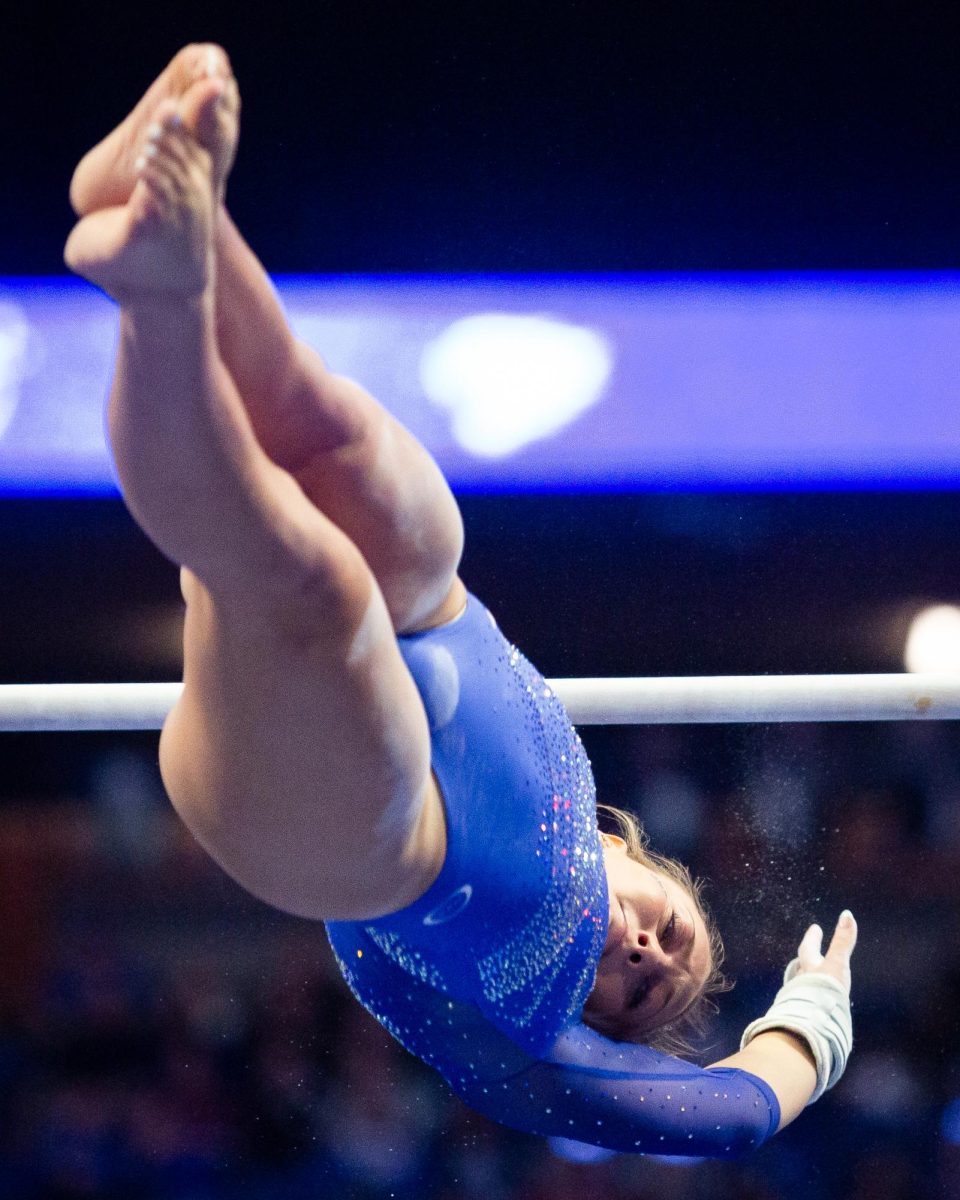 Delaynee Rodriguez spins in the air during her bars routine at the No. 7 Kentucky vs. No. 18 Georgia gymnastics meet on Friday, January 26, 2024, at Rupp Arena in Lexington, Kentucky. Kentucky won 197.950-195.650. Photo by Brady Saylor | Staff