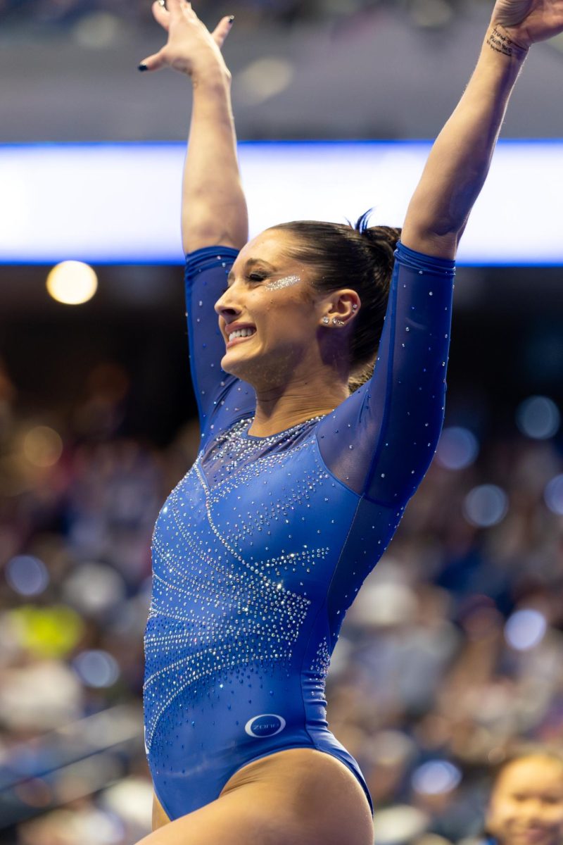 Senior Isabella Magnelli smiles after completing her beam routine during the No. 7 Kentucky vs. No. 18 Georgia gymnastics meet on Friday, January 26, 2024, at Rupp Arena in Lexington, Kentucky. Kentucky won 197.950-195.650. Photo by Ella Porter | Staff