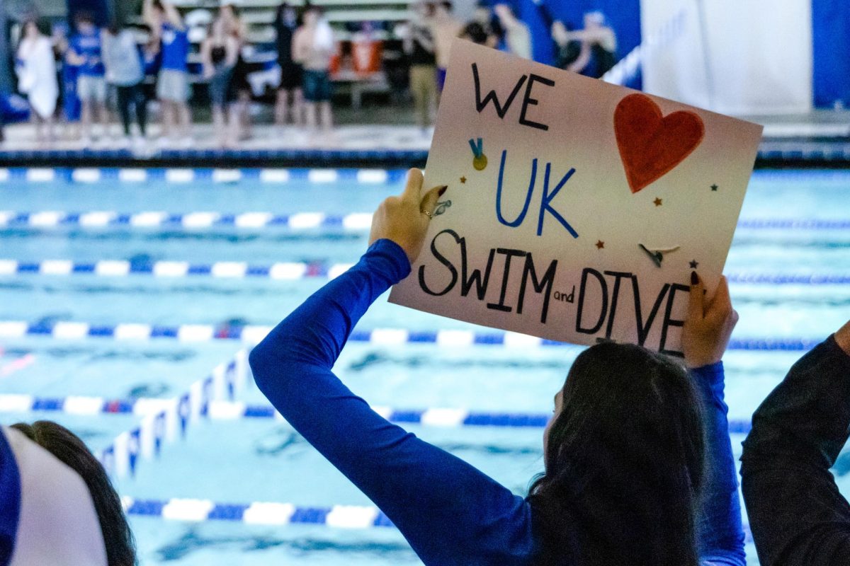 A fan holds a sign during the Kentucky Swim & Dive Senior Night and meet against the University of Cincinnati on Friday, Feb. 2, 2024, at the Lancaster Aquatic Center in Lexington, Kentucky. Kentucky Mens swim & dive won 186-111, while Kentucky Womens swim & dive won 207-93. Photo by Cameron Guagenti
