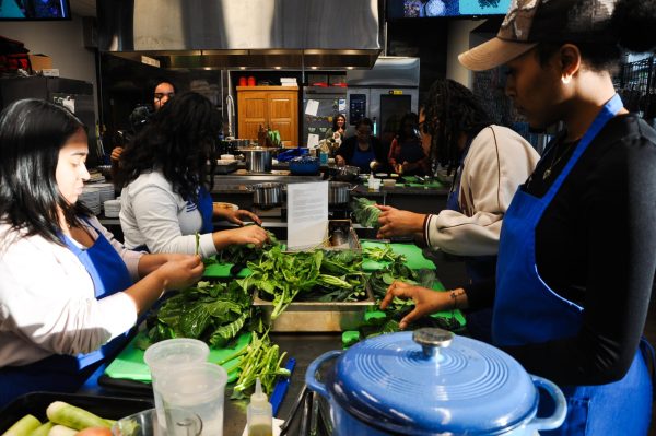 Students prepare collard greens at a Cooking Up Community event on Monday, Feb. 19, 2024, at The 90 at the University of Kentucky in Lexington, Kentucky. Photo by Isabella Sepahban | Staff