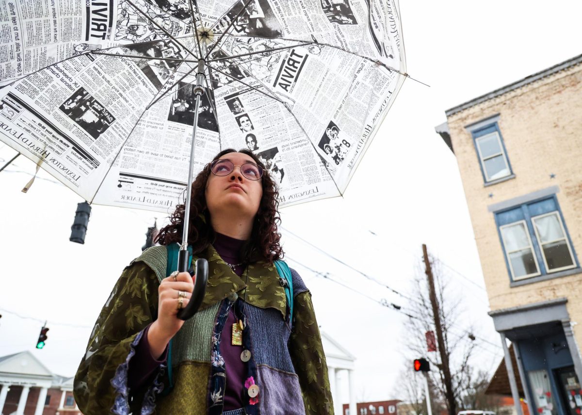 Cynthiana Democrat Regional Editor Kendall Staton holds a Lexington Herald-Leader umbrella on Wednesday, Jan. 24, 2024, outside the Democrat office in Cynthiana, Kentucky. Staton is one of the youngest newspaper editor’s in the country. Photo by Abbey Cutrer | Staff