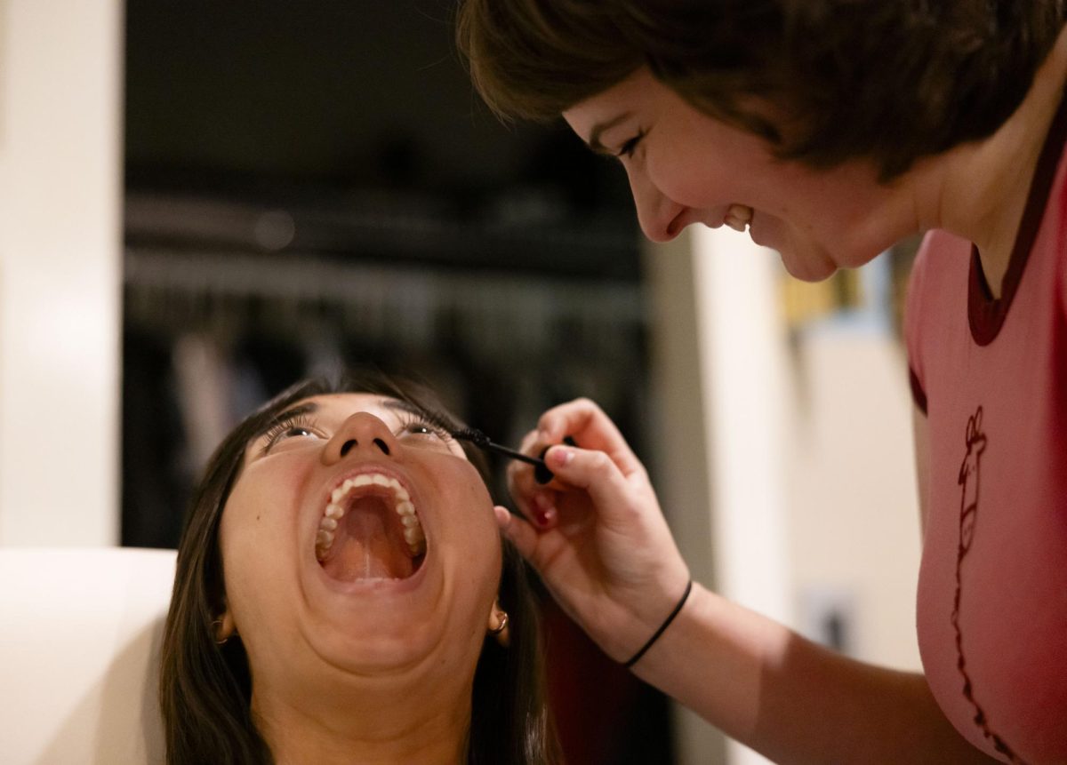 Kaelyn Brooker applies mascara to Denise Waddell, doing the “mascara face,” in her home on Friday, Oct. 13, 2023, in Frankfort, Kentucky. Photo by Bryce Towle.