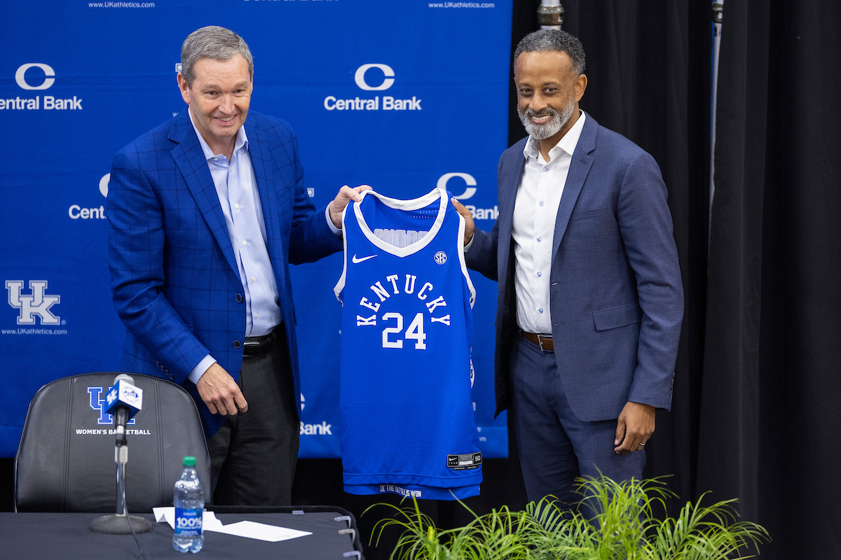Kentucky womens basketball head coach Kenny Brooks and athletic director Mitch Barnhart hold up a Kentucky jersey during Brooks introductory press conference inside the Joe Craft Center on Thursday, March 28, 2024, in Lexington, Kentucky. Photo provided by Chet White | UK Athletics