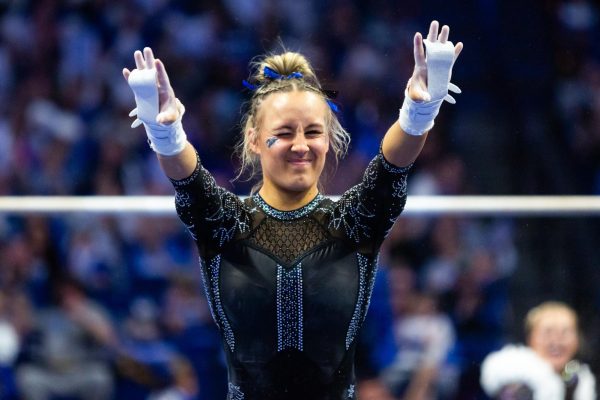 Raena Worley winks after completing her bars routine during the No. 6 Kentucky vs No 5. Florida gymnastics meet on Sunday, March 3, 2024 at Rupp Arena in Lexington, Kentucky. Kentucky lost 198.100-198.225.